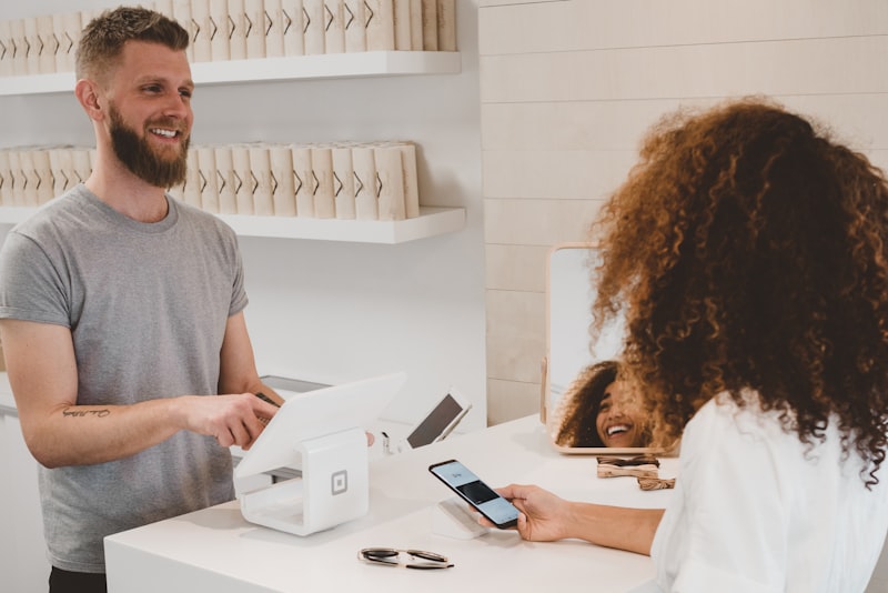 A merchant payment interaction at a checkout counter